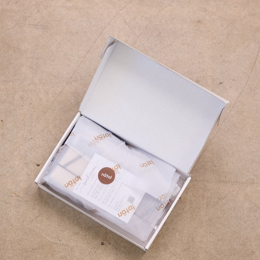 The nātal box opened, showing the kit inside